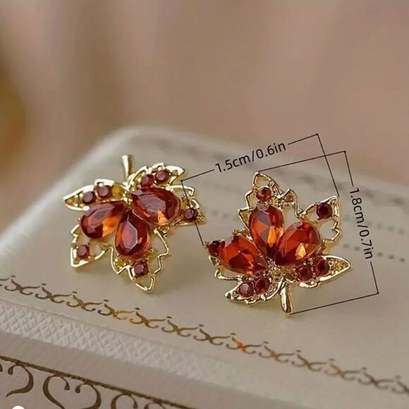 Maple Leaf Shaped Gold Tone Stud Earrings With Red Crystal Accents - Picture 2 of 2